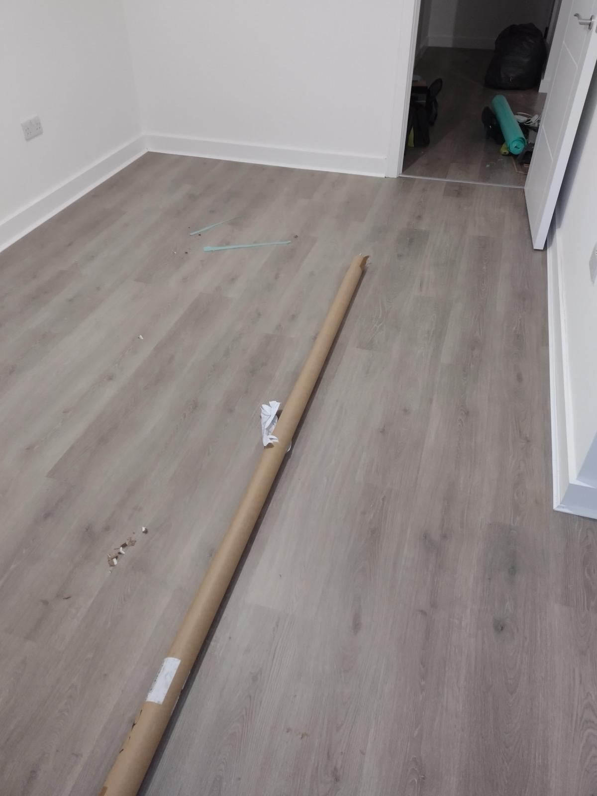 Grey-toned engineered flooring in contemporary apartment renovation