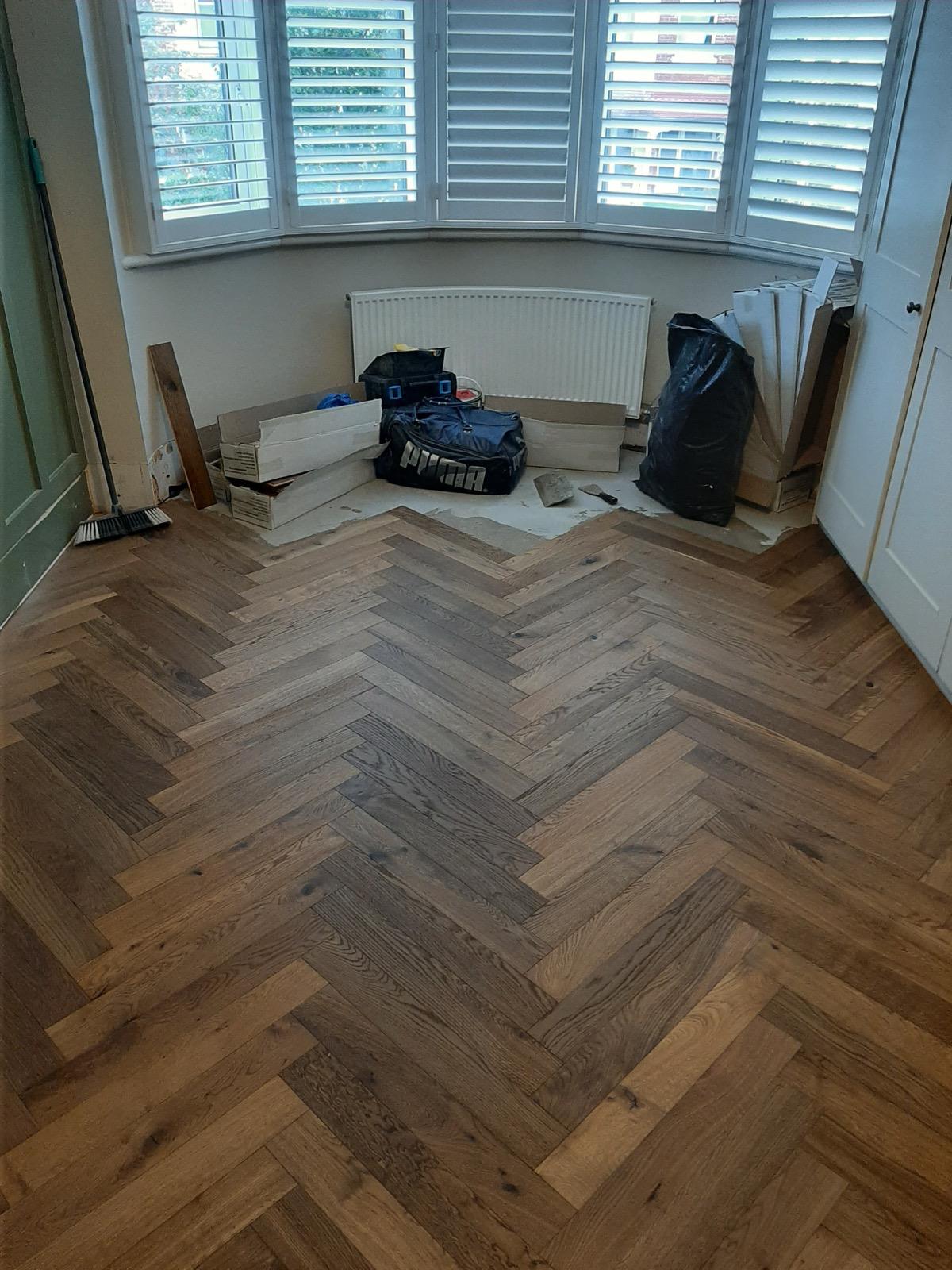 Herringbone flooring detail showing precision-cut joints and border