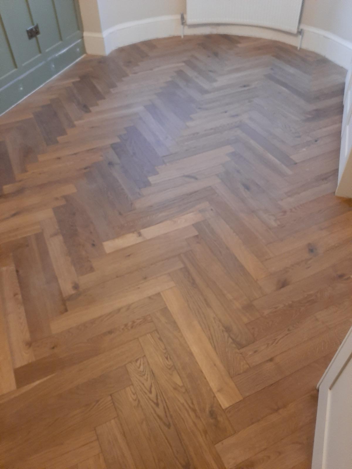 Herringbone parquet flooring in open-plan kitchen and dining area