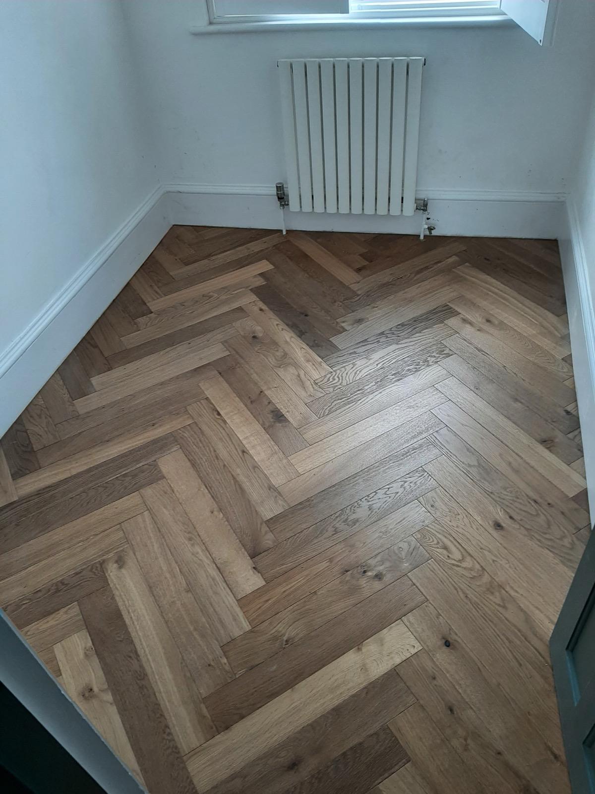 Close-up of herringbone oak flooring with satin oil finish