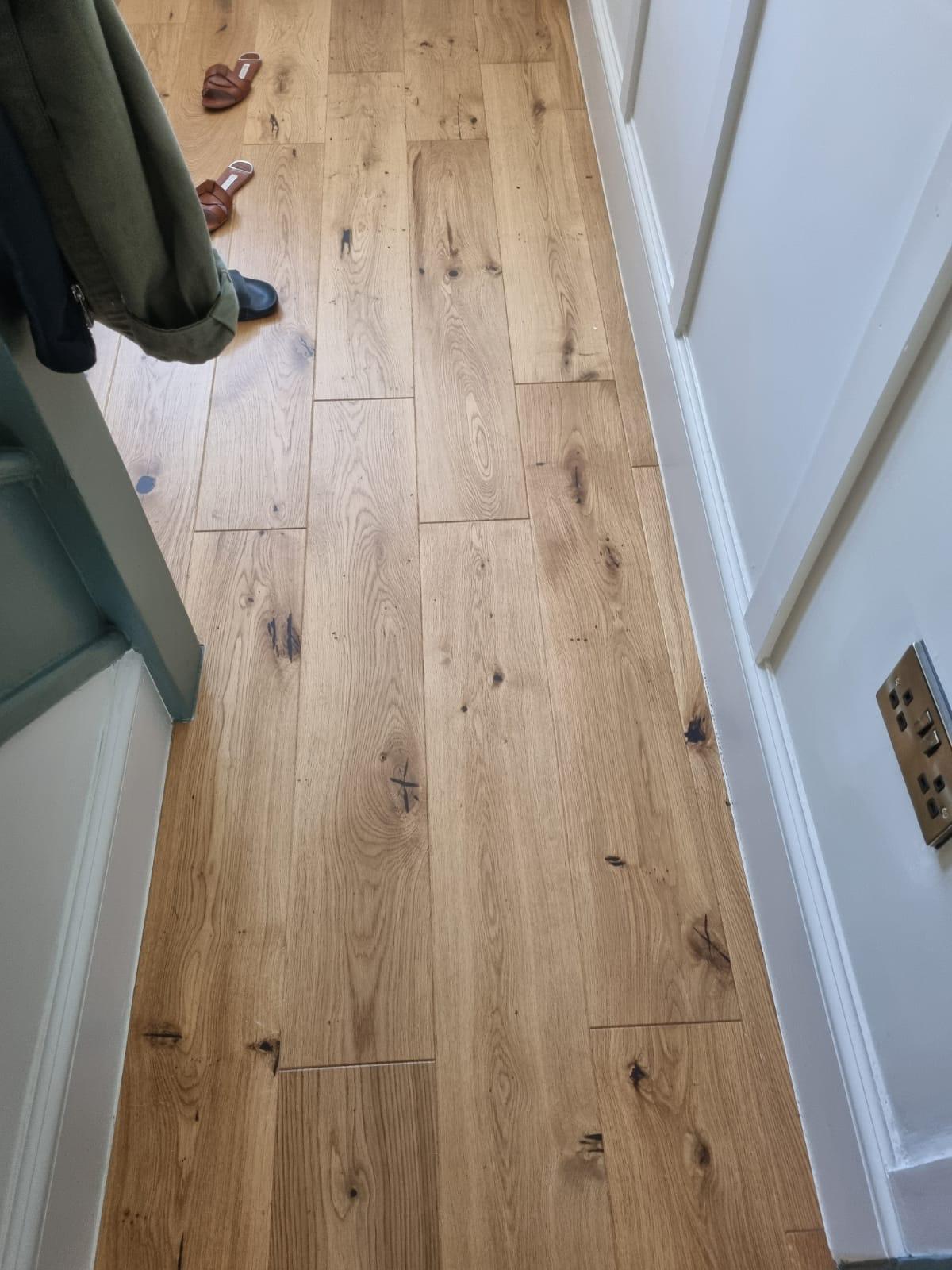 Oak flooring fitted through hallway with clean transition at doorways