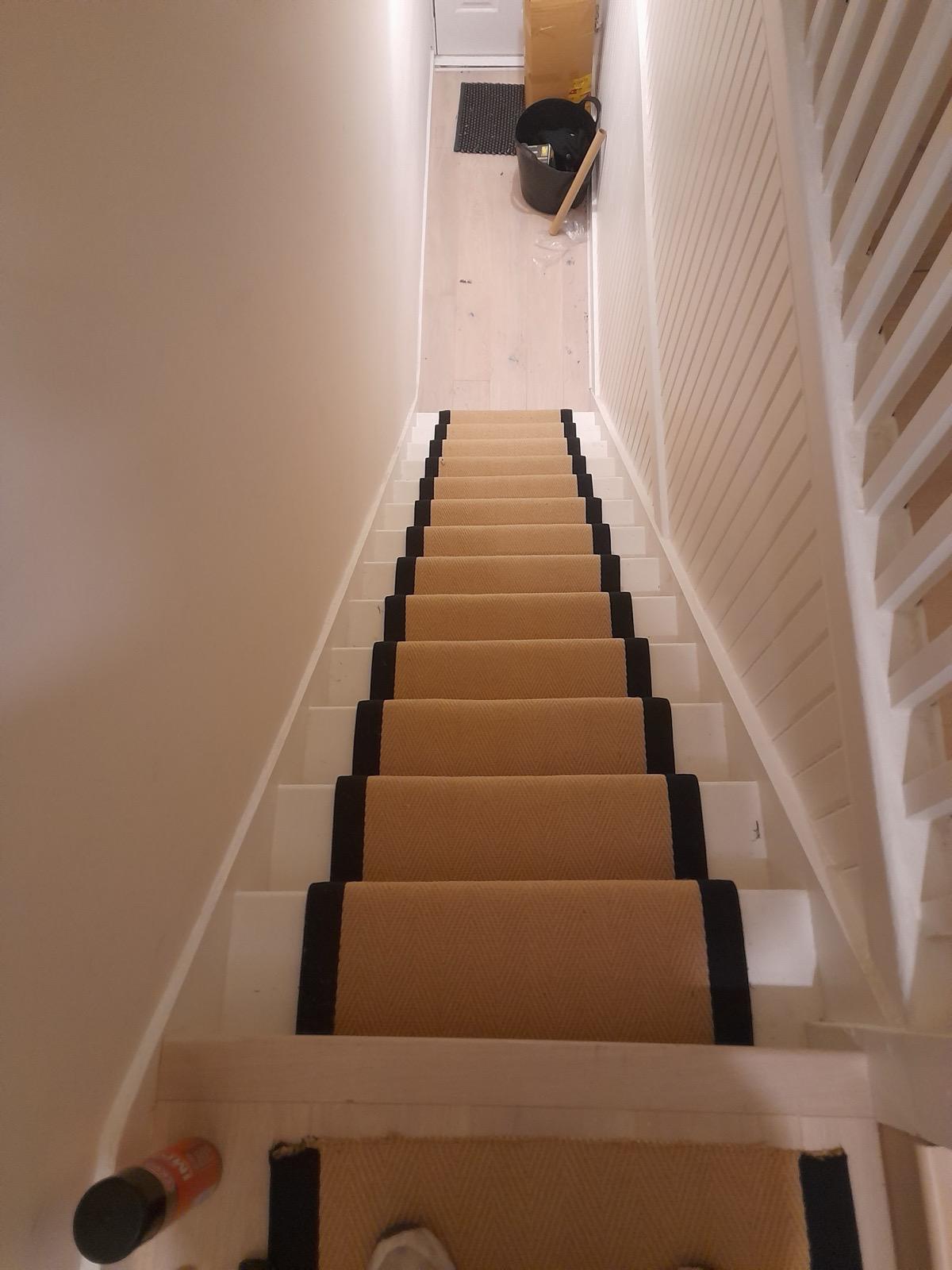 Staircase runner installation with contrasting painted risers